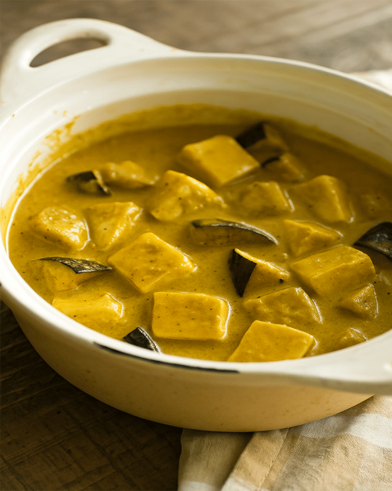 Curry de Dinde aux Aubergines et Lait de Coco Bol de curry vert de dinde et aubergines crémeux, servi avec du riz et garni de coriandre.